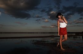 fashion model against florida lake with dramatic lighting